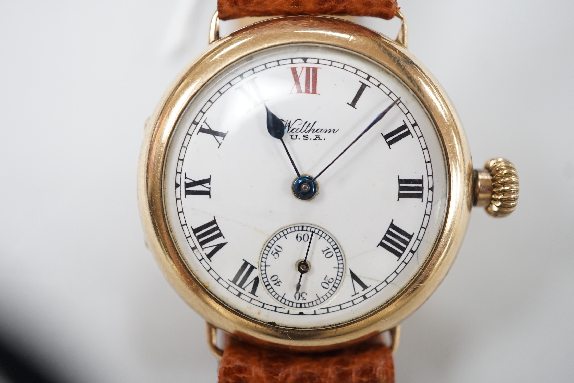 A gentleman's early 20th century 9ct gold Waltham manual wind wrist watch, with Roman dial and subsidiary seconds, on later associated leather strap, case diameter 32mm.